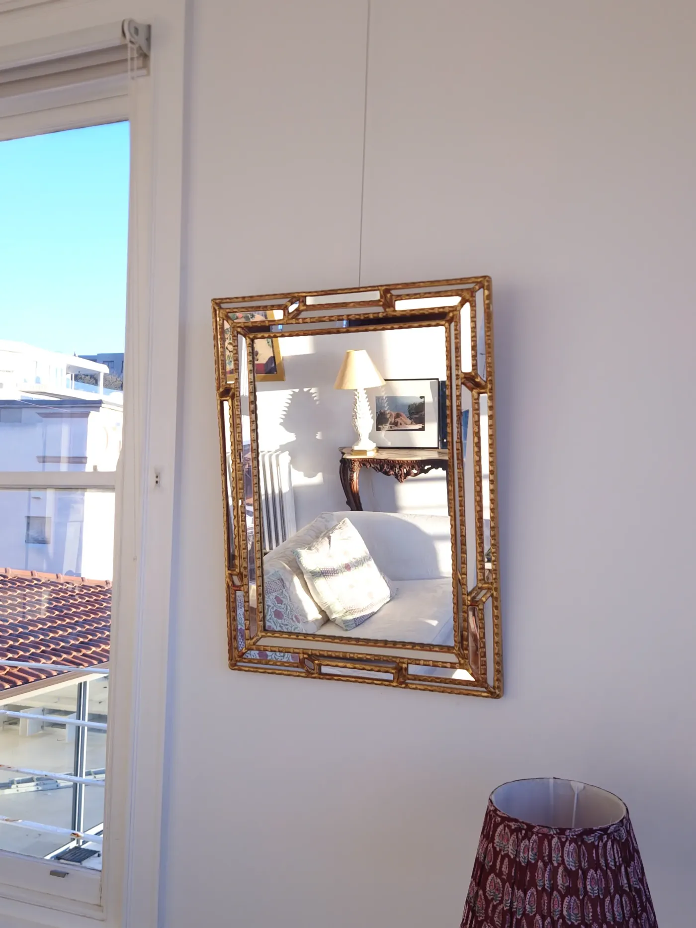 Hollywood Regency multi-faceted gilt mirror